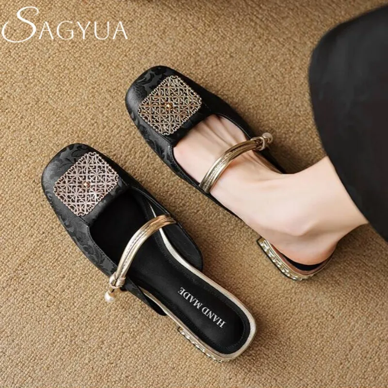 Square toe leather loafers with metallic details complementing slim jeans