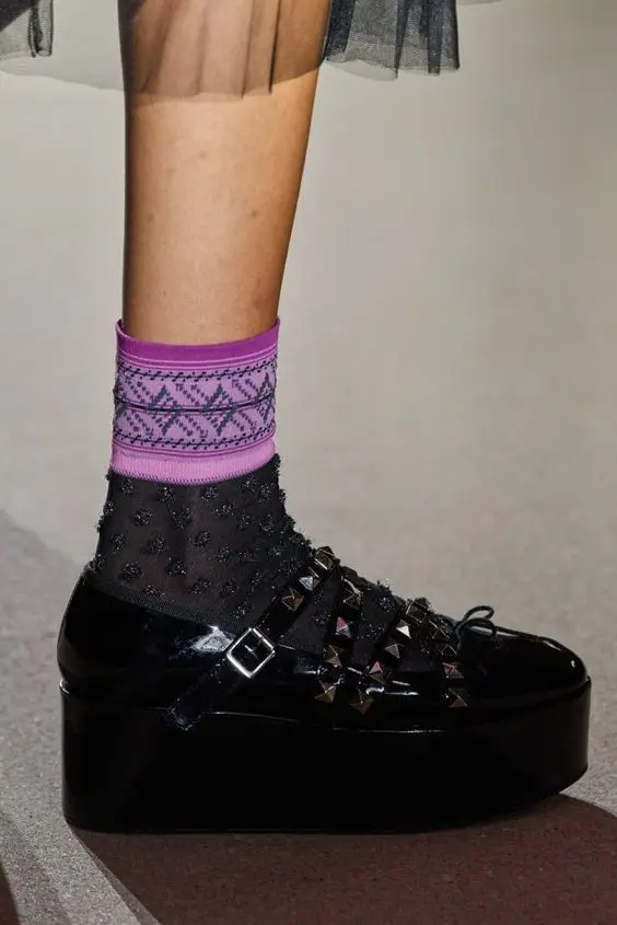 Patent leather platform loafers with edgy cross straps and rivet details for bold fashion statements