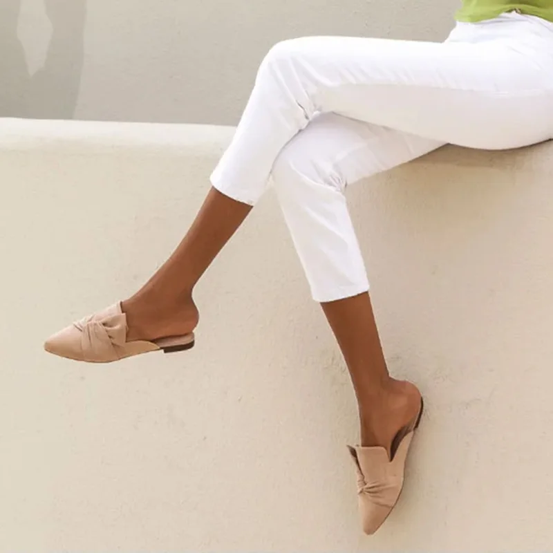 Elegant pointed toe suede knot mules with flat backless loafer design