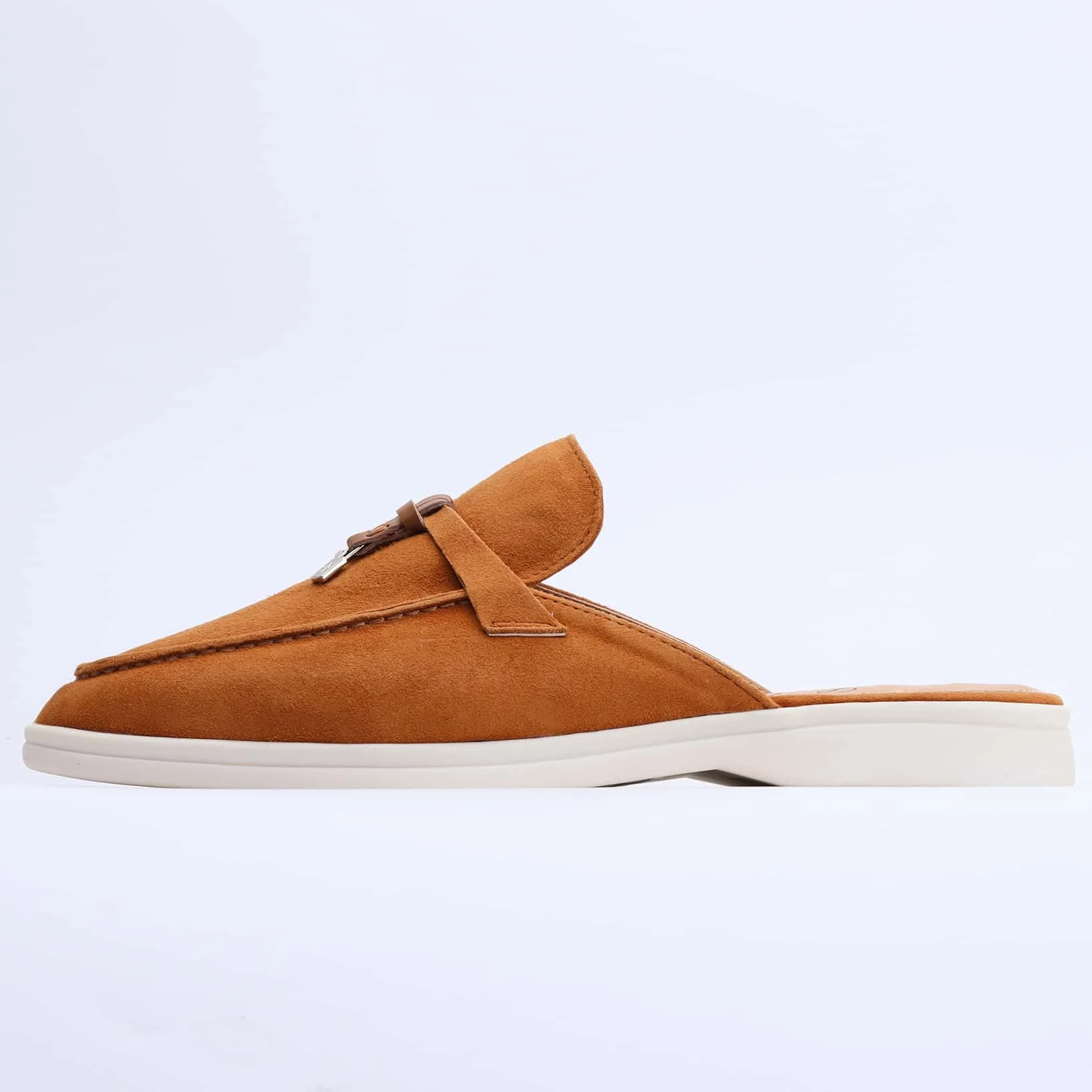 Stylish suede loafer mules combined with tailored jeans for a complete fashionable outfit