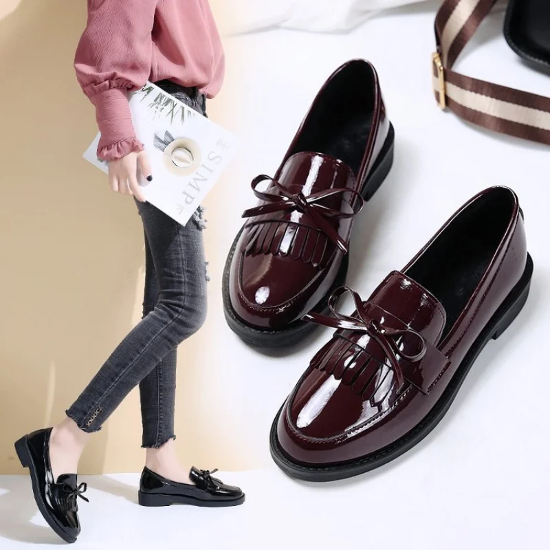 Patent leather chunky platform loafers with tassel and bow details for a bold feminine style